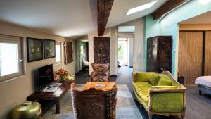 a living room with a couch and a table at Villa Troletti, hôtel particulier de luxe en Provence in L'Isle-sur-la-Sorgue