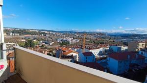 a view of a city from the balcony of a building at Coimbra's Black & White in Coimbra