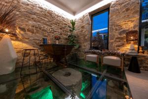 a room with a glass floor and a stone wall at Hotel Sarela Natura in Santiago de Compostela