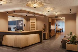 a lobby with a reception counter and a living room at Hotel La Müda in Badia