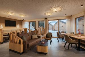 a living room with a couch and a table at Hotel La Müda in Badia