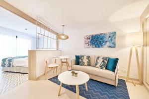 a living room with a couch and a bed at Eurostars Ibiza in Ibiza Town +58 photos