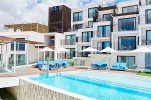 a swimming pool in front of a building at Eurostars Ibiza in Ibiza Town