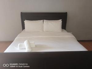a bed with two rolls of towels on it at Entire rental unit in Pretoria