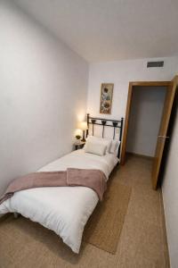a bedroom with a large bed in a room at RelaxMaria in Sant Carles de la Ràpita