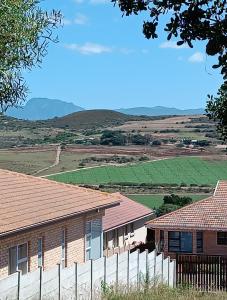 a house with a fence in front of a field at J&B Tuiste in Reebok