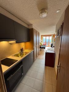 a kitchen with a sink and a counter top at "Le Ptit Nid" studio avec vue à couper le souffle à Leysin ! in Leysin
