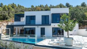 a house with a swimming pool and a villa at Villa Lana by Villas Guide in Vela Luka