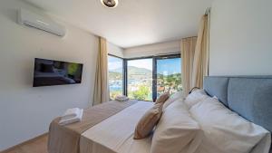 a bedroom with a large bed with a large window at Villa Lana by Villas Guide in Vela Luka +28 photos