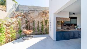 a kitchen and dining area with a wall at Villa Lana by Villas Guide in Vela Luka
