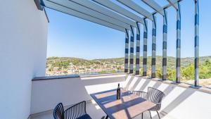 a balcony with a table and chairs and a view at Villa Lana by Villas Guide in Vela Luka