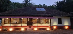 a house with a roof with solar panels on it at Taramrata Homestay in Gokarna