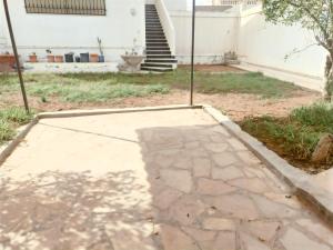 a stone walkway in front of a house with stairs at Sunshine Villa in Gabès