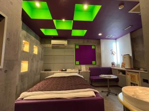 a hospital room with a bed and green lights at ホテル フローレス in Tsubame