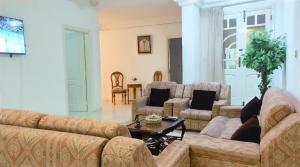 a living room with couches and a coffee table at Sunshine Villa in Gabès
