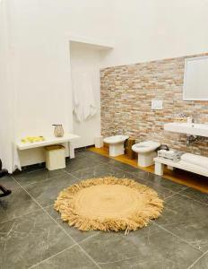 a bathroom with two toilets and a rug on the floor at Dongiovanni Suite in Lecce +33 photos