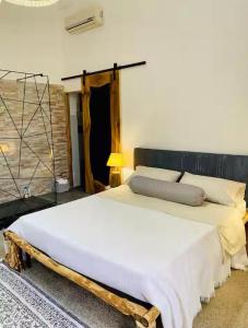 a bedroom with a large bed with a wooden headboard at Dongiovanni Suite in Lecce