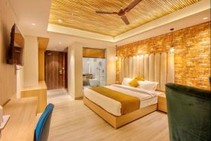 a bedroom with a bed and a brick wall at Hotel Katson Castle with Sunset View Dharamshala in Dharamshala