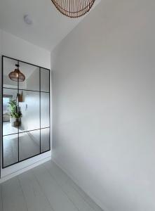 a room with white walls and a glass wall at BEACH apartment met directe toegang tot het STRAND ! in Knokke-Heist +25 photos