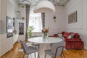 a living room with a table and chairs and a couch at NEBarrabona in Győr +14 photos