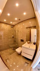 a bathroom with a sink and a toilet and a mirror at Beit Colette in Beït ed Dîne +17 photos