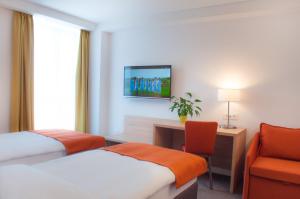 a hotel room with two beds and a chair at Hotel Park Superior 3* in Čakovec +39 photos