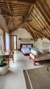 a large room with two beds and a table at Sea Turtle Villas in Gili Islands +57 photos