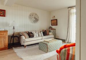 a living room with a couch and a table at Dumbarnie East Cottage in Kirkton of Largo