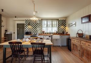 a kitchen with a table and chairs in it at Dumbarnie East Cottage in Kirkton of Largo