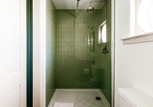 a bathroom with a shower with green tiles at Dumbarnie East Cottage in Kirkton of Largo +46 photos