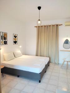 a bedroom with a large bed in a room at Panagiotis Studios in Laganas