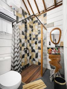 a bathroom with a toilet and a shower at Maza Lodge & Spa in Kejajar +13 photos
