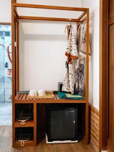 a walk in closet with a desk and a tv at Maza Lodge & Spa in Kejajar