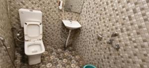 a bathroom with a toilet and a sink at Hotel Utsav in Khatīma +33 photos