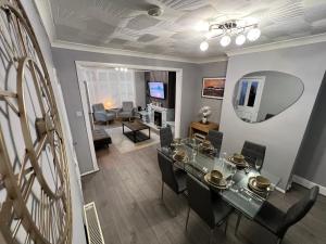 a dining room and living room with a table and chairs at Victoria Maidstone Tranquil Retreat in Maidstone