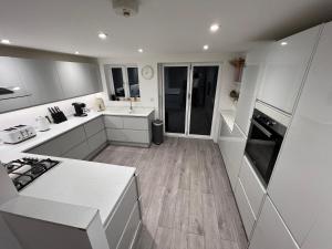 a kitchen with white counters and white appliances at Victoria Maidstone Tranquil Retreat in Maidstone