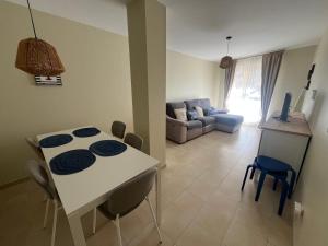 a kitchen and living room with a table and chairs at Apartamento Senda in Comillas