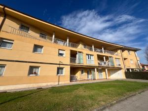 an apartment building with balconies and a yard at Apartamento Senda in Comillas