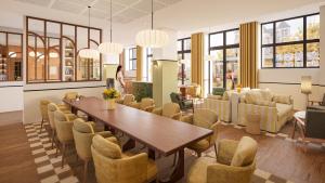 a dining room with a table and chairs at ARBELLIA Appart'Hôtel Châlons en Champagne in Chalons en Champagne