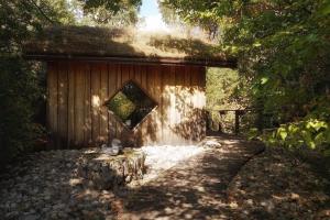 a small building with a mirror on the side of it at Chalet toit vegétalisé in Champfromier