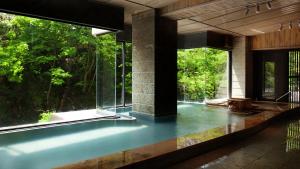 a room with large windows and a pool of water at Aizu-Wakamatsu "Yukkura Inn" self-service INN in Aizuwakamatsu