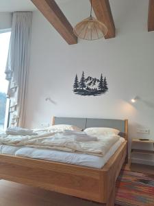a bedroom with a bed in a room with a window at Chata Za Studeným potokom in Habovka