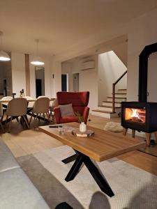 a living room with a couch and a fireplace at Chata Za Studeným potokom in Habovka