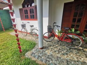 two bikes are parked next to a house at Villa Rina in Kottagoda