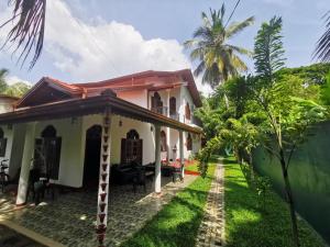 a house with a garden in front of it at Villa Rina in Kottagoda