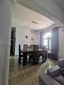 a dining room with a table and chairs at Villa Rina in Kottagoda