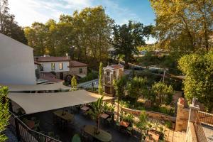 an overhead view of a garden with tables and a building at Hotel Sarela Natura in Santiago de Compostela