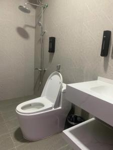 a bathroom with a white toilet and a sink at 1993 Homestay G&C Quảng Trị in Quang Tri