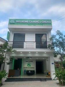 a white building with a sign on top of it at 1993 Homestay G&C Quảng Trị in Quang Tri