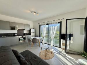 a living room with a couch and a table at T2 à 200m des plages in Propriano +4 photos